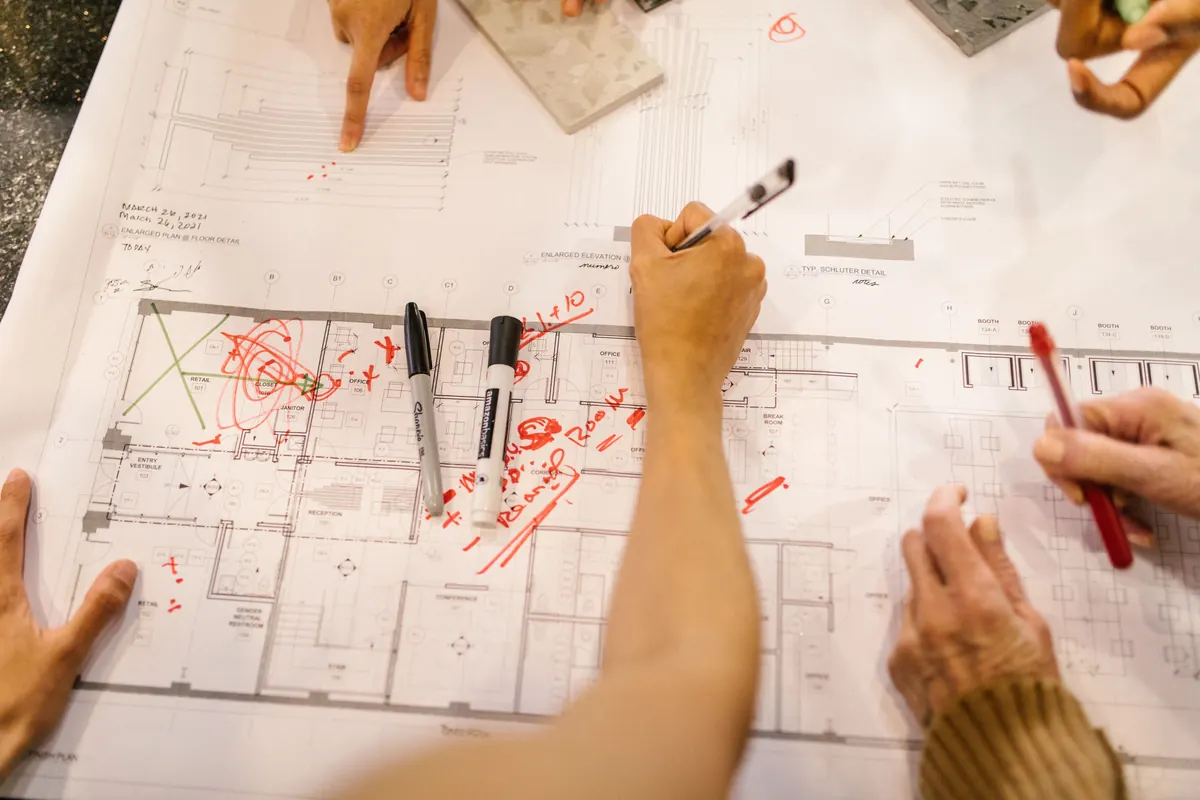 Team reviewing a building plan and product schedule
