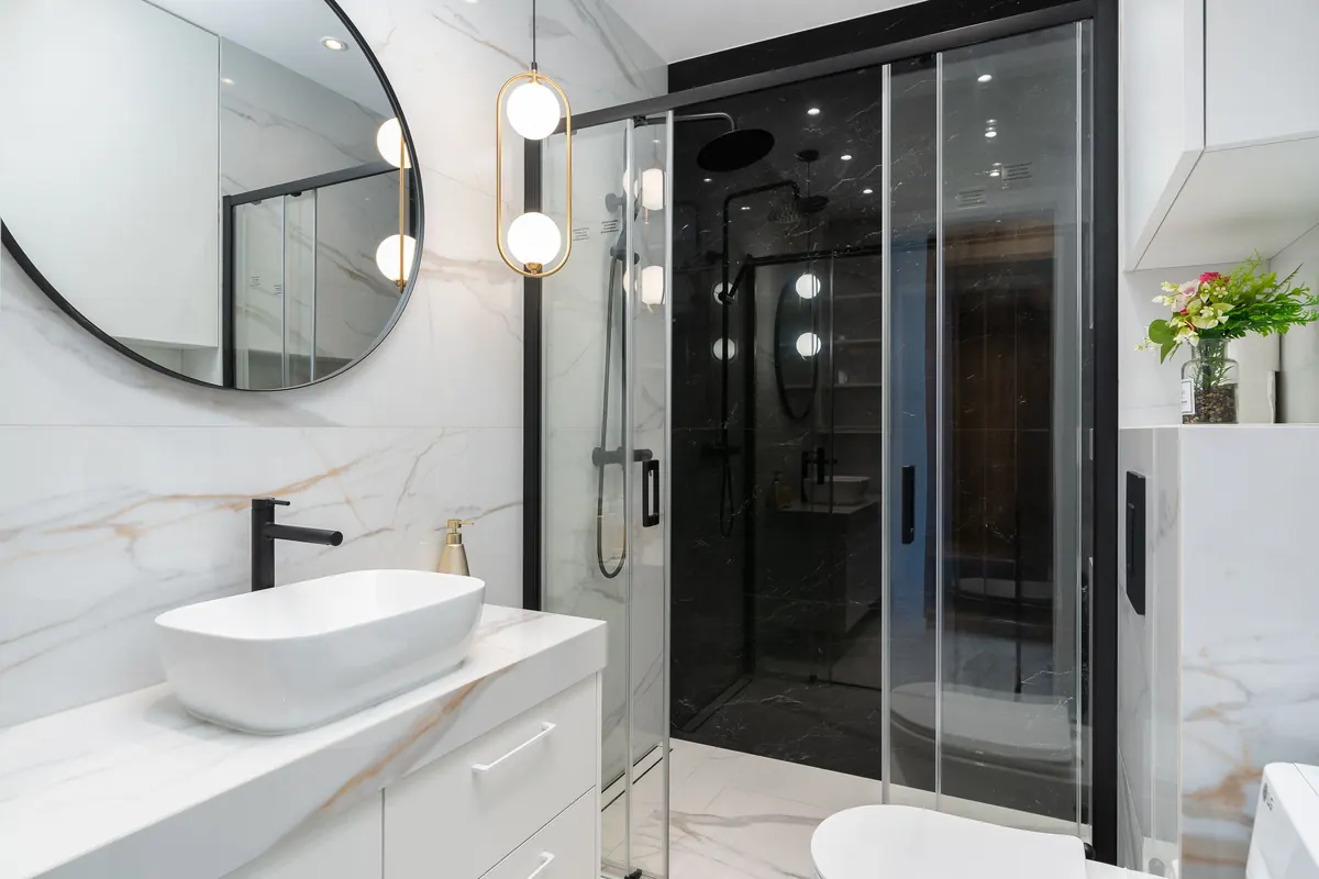 Bathroom display with basin, mirror, shower, and supporting fittings