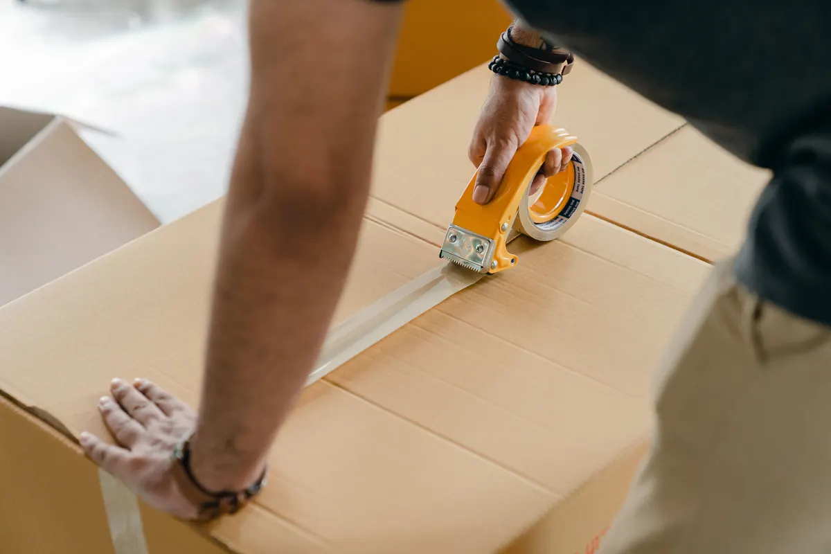 Worker sealing a carton for a bulk order